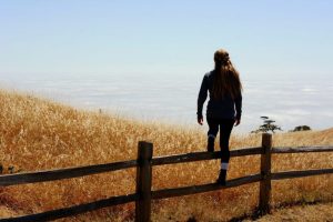 woman reflecting autum pasture