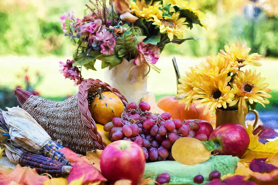 A Thanksgiving cornucopia filled with fruits and flowers